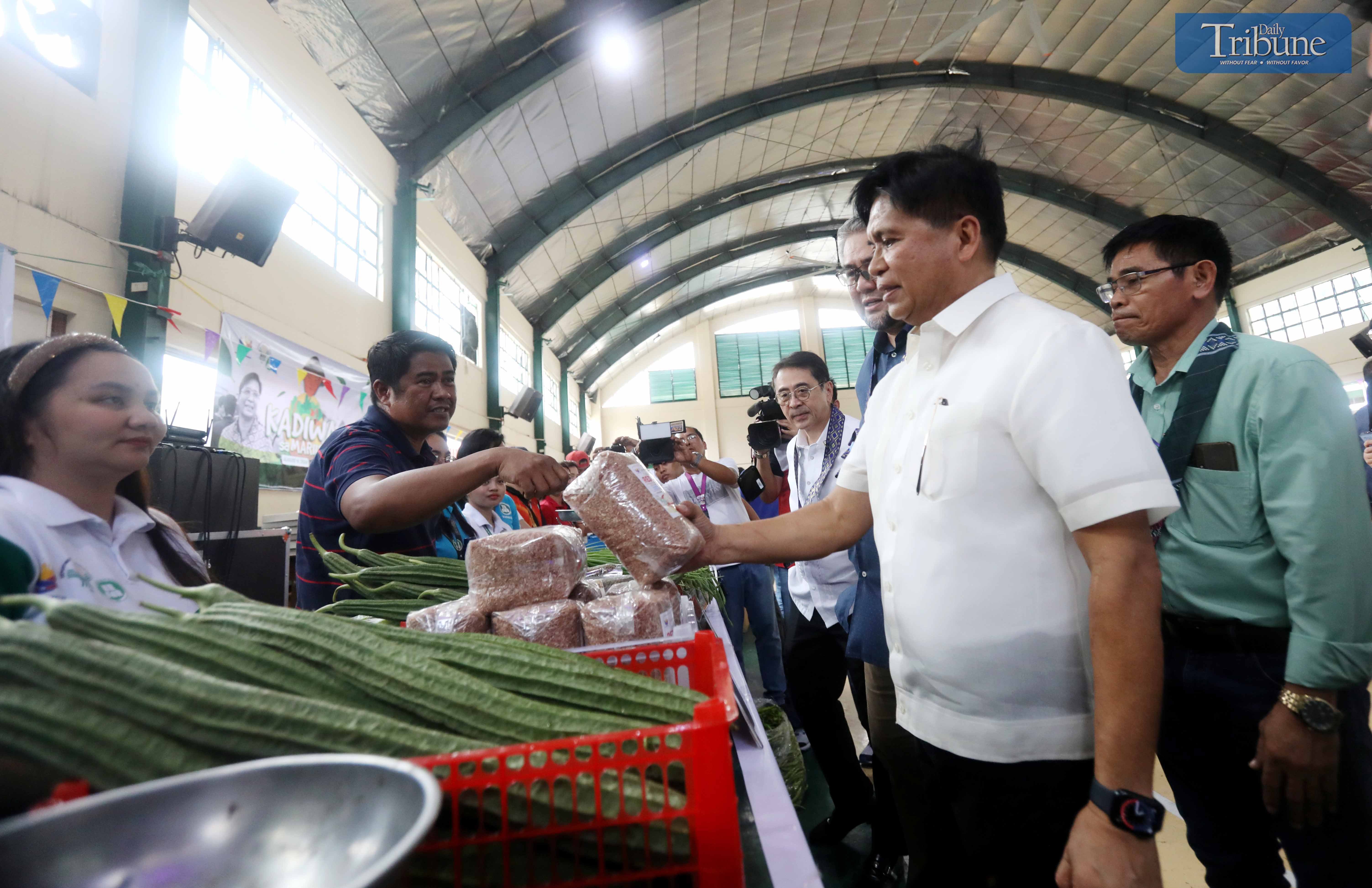 LOOK: National Irrigation Administration (NIA) administrator Eduardo Eddie Guillen, along with Department of Agriculture USec. Christopher Morales, checks out the stalls from different regions selling various products at the Kadiwa Market during the launch of the "Murang Bigas sa NIA @29 pesos" at the NIA Headquarters in Quezon City on Thursday, 8 August 2024. This project supports President Ferdinand Marcos Jr.'s goal of ensuring food security and boosting the country's economy. | via Analy Labor